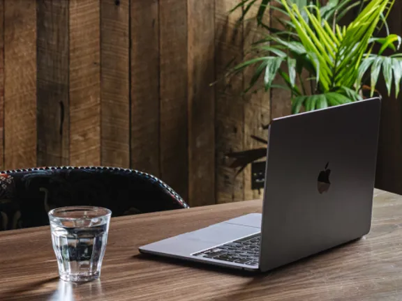 Laptop on table in the timberyard at The Dean Docklands