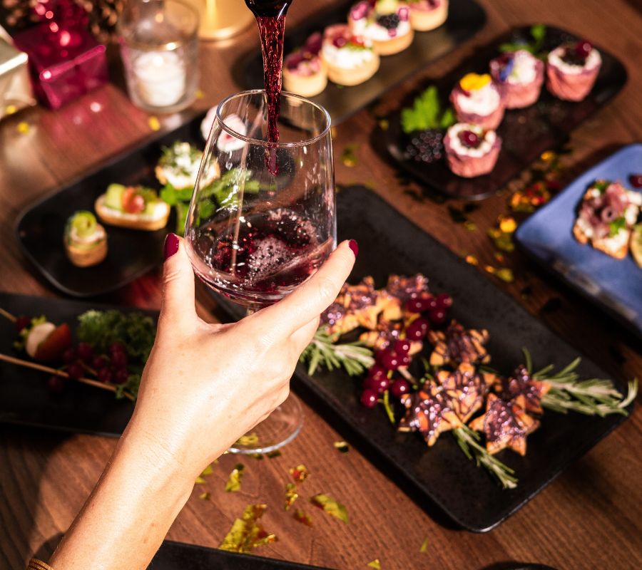 Woman enjoying wine at The Dean Hotels during Christmas
