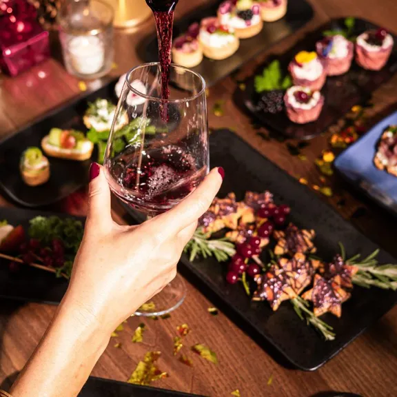 Woman enjoying wine at The Dean Hotels during Christmas