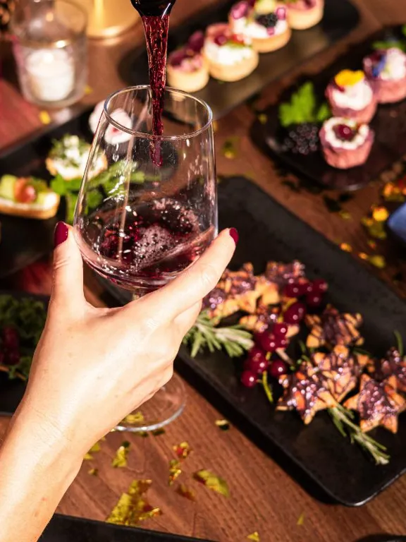 Woman enjoying wine at The Dean Hotels during Christmas