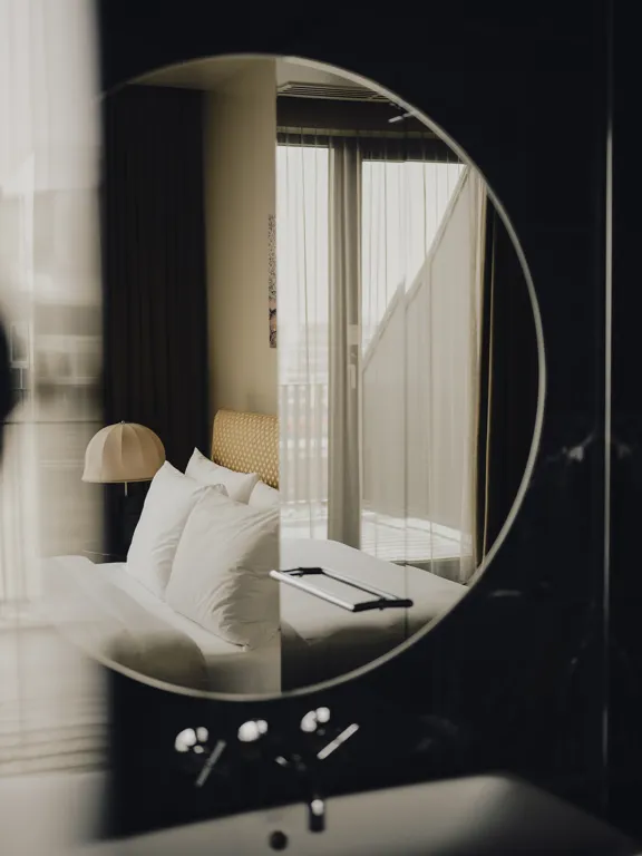 Reflection in the bathroom mirror of the Double Room in The Dean Munich