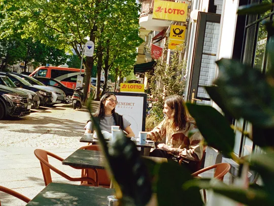 Two woman sitting outside cafe beside The Dean Berlin