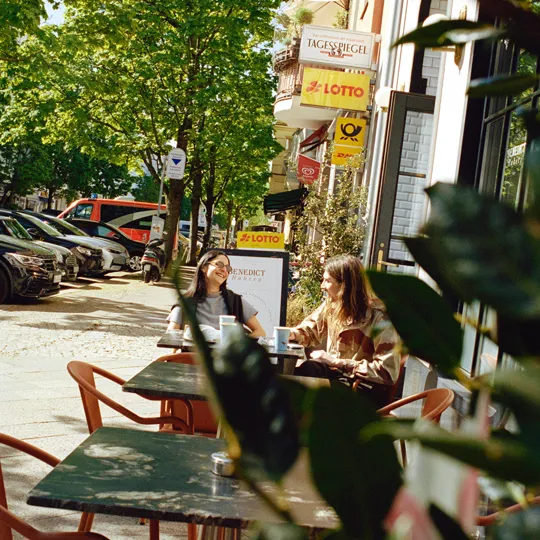 Two woman sitting outside cafe beside The Dean Berlin
