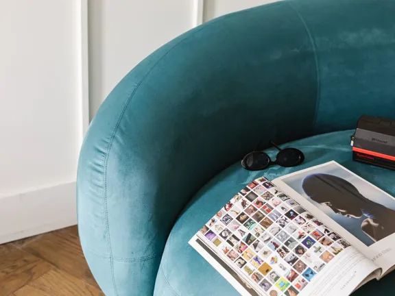 Teal armchair in the reading corner of The Copper Suite at The Dean Cork.