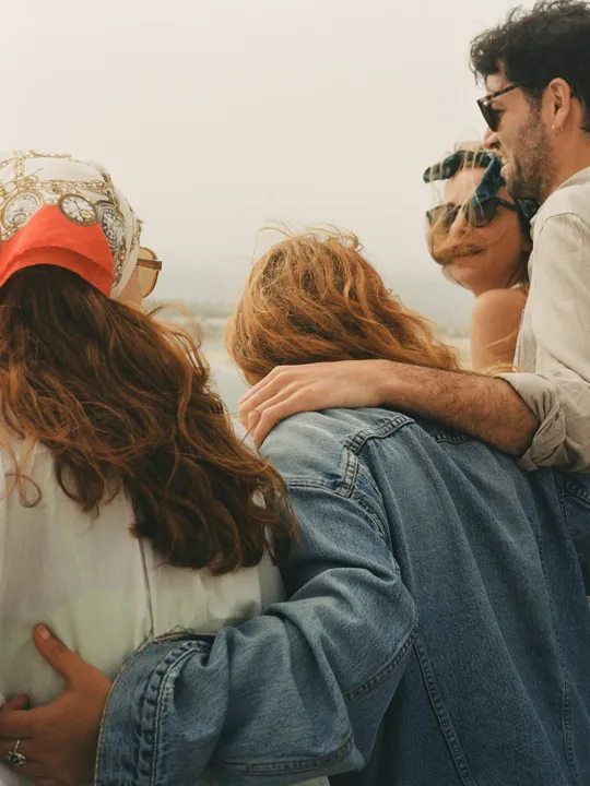 Group of people hanging out by the beach.