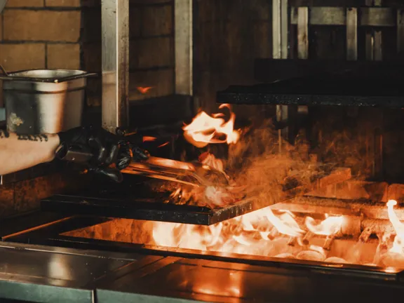 Open Flame cooking steak in Ryleighs at the Dean Docklands