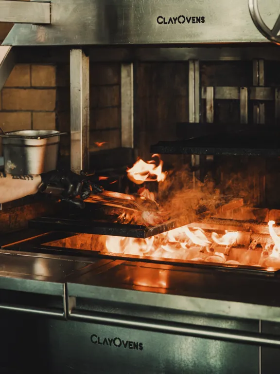 Open Flame cooking steak in Ryleighs at the Dean Docklands