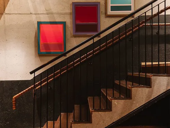 Artwork hanging on wall in the stairwell of the Dean Galway