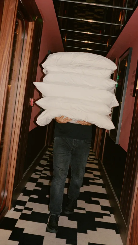 Man walking with pillows in the Dean Dublin Centre