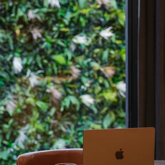 Laptop on table in the timberyard at The Dean Docklands