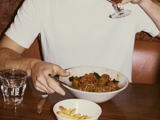 Man enjoying food and drinks at Sidekick in The Dean Docklands